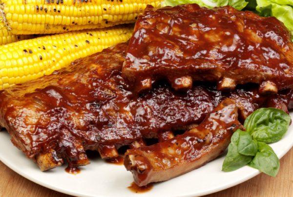 A rack of scculent pork ribs qith sweetcorn